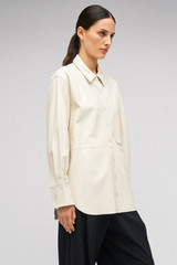 Profile view of model wearing the Oroton Leather Overshirt in Paper White and 100% Leather for Women