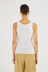 Profile view of model wearing the Oroton Knit Tank in White and 83% Viscose, 17% Polyester for Women