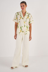 Profile view of model wearing the Oroton Field Daisy Camp Shirt in String and 100% Linen for Women