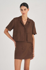 Profile view of model wearing the Oroton Cropped Scallop Camp Shirt in Dark Chocolate and 100% Linen for Women