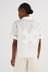 Profile view of model wearing the Oroton Lace Detail Camp Shirt in Antique White and 100% Linen for Women