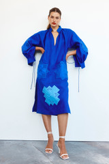 Profile view of model wearing the Oroton Embroidered Patch Dress in Azure and Linen for Women