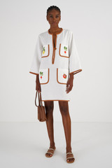 Profile view of model wearing the Oroton Embroidered Vegetable Tunic Dress in Antique White and 100% Linen for Women