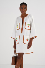 Profile view of model wearing the Oroton Embroidered Vegetable Tunic Dress in Antique White and 100% Linen for Women