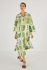 Profile view of model wearing the Oroton Fern Garden Column Dress in Cream and 100% Silk for Women