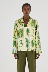 Profile view of model wearing the Oroton Fern Garden Long Sleeve Shirt in Cream and 100% Silk for Women