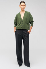 Profile view of model wearing the Oroton Black Flat Front Pant in Black and 53% polyester, 42% virgin wool, 5% elastane for Women . IP:3