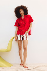 Profile view of model wearing the Oroton Broderie Camp Shirt in Poppy and 100% Linen for Women