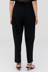 Profile view of model wearing the Oroton Pleat Pant in Black and 53% Polyester 42% Wool 5% Elastane for Women . IP:5