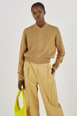 Profile view of model wearing the Oroton Mesh Stitch Bomber in Tobacco and 83% Viscose 17% Polyester for Women