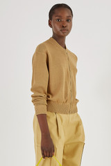 Profile view of model wearing the Oroton Mesh Stitch Bomber in Tobacco and 83% Viscose 17% Polyester for Women