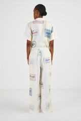 Profile view of model wearing the Oroton Patch Label Pant in Lemon Zest and 100% Linen for Women