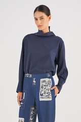 Profile view of model wearing the Oroton High Neck Silk Blouse in North Sea and 100% Silk for Women