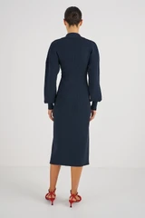 Profile view of model wearing the Oroton Long Sleeve Rib Knit Dress in North Sea and 83% Viscose 17 % Polyester for Women