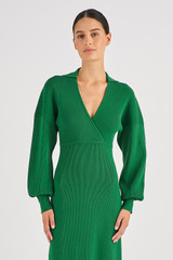 Profile view of model wearing the Oroton Long Sleeve Rib Knit Dress in Juniper Green and 83% Viscose 17 % Polyester for Women
