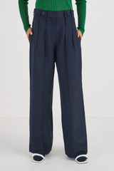 Profile view of model wearing the Oroton Tab Detail Pleat Pant in North Sea and 58% Viscose 42% Linen for Women