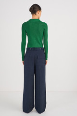 Profile view of model wearing the Oroton Tab Detail Pleat Pant in North Sea and 58% Viscose 42% Linen for Women