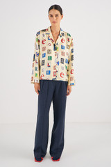 Profile view of model wearing the Oroton Alphabet Print Camp Shirt in Jute and 100% Silk for Women