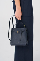 Profile view of model wearing the Oroton Margot Mini Bucket Bag in North Sea and Pebble Leather for Women . IP:5