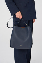 Profile view of model wearing the Oroton Margot Hobo in North Sea and Pebble Leather for Women