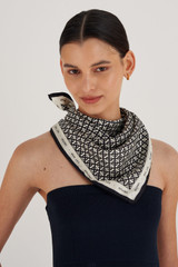 Profile view of model wearing the Oroton All Over Logo Silk Scarf in Cream/Black and 100% Silk for Women . IP:3