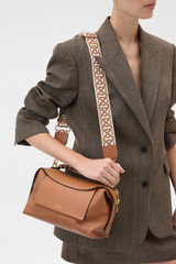 Profile view of model wearing the Oroton Logo Bag Strap in Cognac/Ecru and Premium smooth leather for Women . IP:2