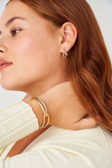 Profile view of model wearing the Oroton Nora Cuff in Gold/Silver and Brass Base With Rhodium Plating for Women . IP:3