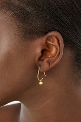 Profile view of model wearing the Oroton Jaclyn Drop Hoops in Worn Gold and  for Women
