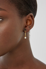 Profile view of model wearing the Oroton Jaclyn Drop Hoops in Worn Gold/White and  for Women