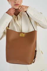 Profile view of model wearing the Oroton Kerr Hobo in Brandy and Smooth Leather for Women