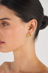Profile view of model wearing the Oroton Leora Mini Hoops in Worn Gold/Silver/Clear and Brass base metal with precious metal plating/stone for Women