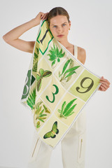 Profile view of model wearing the Oroton Fern Garden Silk Scarf in Cream and 100% Silk for Women