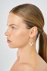 Profile view of model wearing the Oroton Marlee Triple Hoops in Worn Gold/White and Brass for Women . IP:3