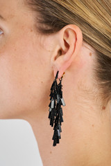 Profile view of model wearing the Oroton Vera Drop Earrings in Black and 100% Metal for Women