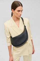 Profile view of model wearing the Oroton Penny Hobo in Black and Smooth leather for Women . IP:2