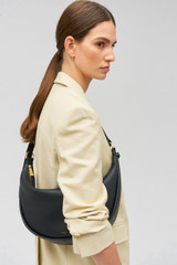 Profile view of model wearing the Oroton Penny Hobo in Black and Smooth leather for Women . IP:3
