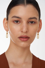 Profile view of model wearing the Oroton Hadley Double Huggies in Worn Gold and  for Women