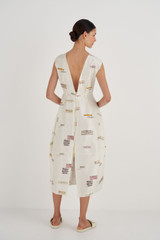 Profile view of model wearing the Oroton Structured Spaced Label Dress in Soft Cream and 100% Silk for Women