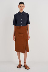 Profile view of model wearing the Oroton Utility Skirt in Tan and 100% Cotton for Women