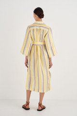 Profile view of model wearing the Oroton Stripe Dress in Daisy and 100% Silk for Women