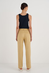 Profile view of model wearing the Oroton Relaxed Leg Pant in Raffia and 81% Viscose, 17% Cotton, 2% Elastane for Women