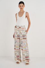 Profile view of model wearing the Oroton Label Print PJ Pant in Soft Cream and 100% Silk for Women