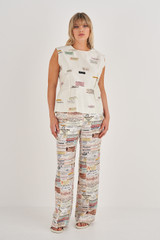 Profile view of model wearing the Oroton Spaced Label Shell Top in Soft Cream and 100% Silk for Women