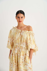 Profile view of model wearing the Oroton Garden Floral Dress in Sugarcane and 100% Linen for Women