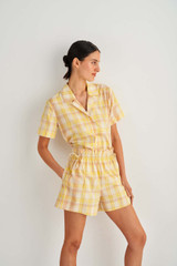 Profile view of model wearing the Oroton Check Short in Cornsilk and 86% Cotton 14% Viscose for Women