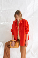 Profile view of model wearing the Oroton Poplin Long Sleeve Shirt in True Red and  for Women . IP:2