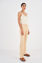 Profile view of model wearing the Oroton Rib Flare Pant in Creamed Honey and 77% Viscose 23% Polyester for Women