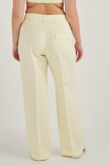 Profile view of model wearing the Oroton Pleat Detail Pant in Lemon Butter and 58% Viscose, 42% Linen for Women