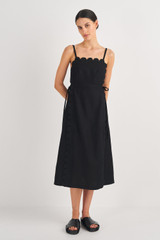 Profile view of model wearing the Oroton Linen Apron Dress in Black and 100% Linen for Women