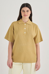 Profile view of model wearing the Oroton Mesh Stitched Polo in Raffia and 83% Viscose, 17% Polyester for Women